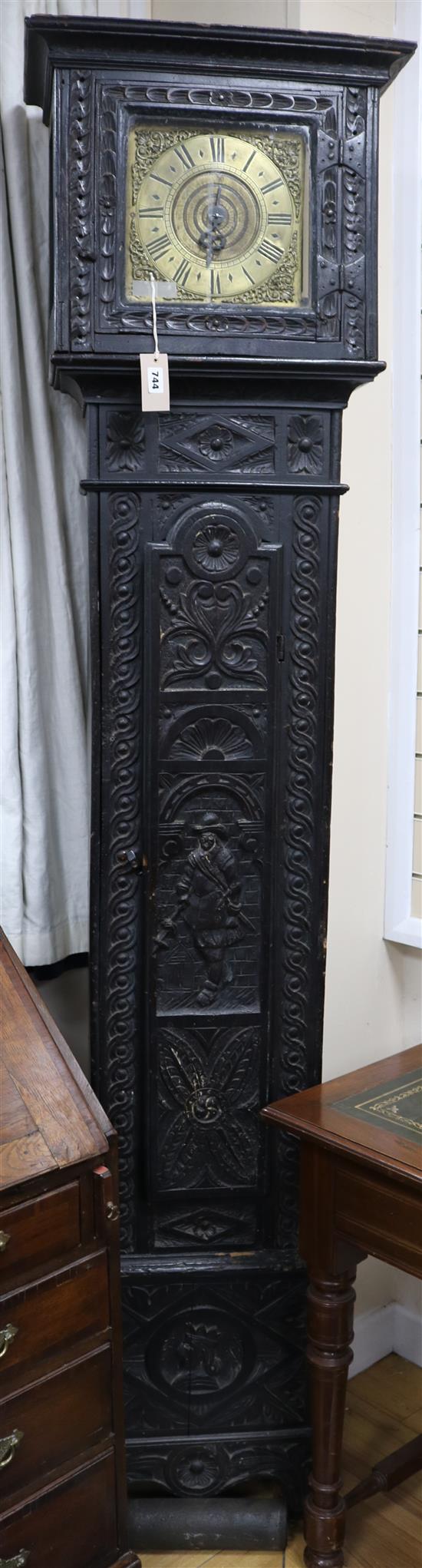 A 17th century style ebonised carved oak thirty hour longcase clock, with single hand dial